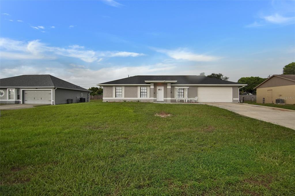 A single-story house with a gray exterior, white trim, and a two-car garage — 2728 COURTLAND BOULEVARD, DELTONA, FL