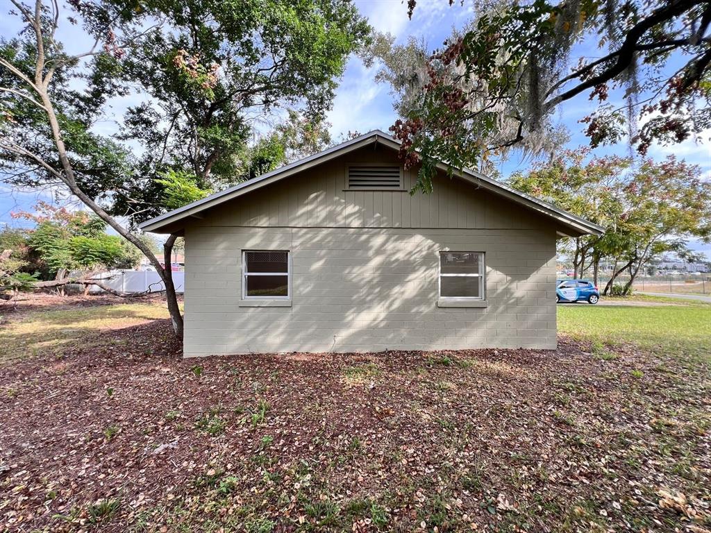 A beige, single-story concrete block building with two windows and a gable roof — 107 OAKLAND DRIVE, DELAND, FL