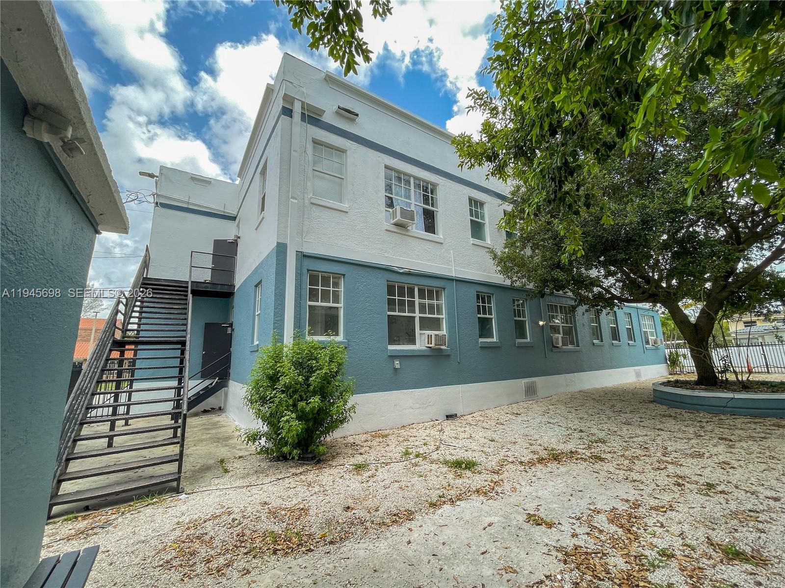 A two-story building with blue and white stucco walls and an exterior metal staircase — 36 NE 65th St, Miami FL 33138, MIAMI, FL