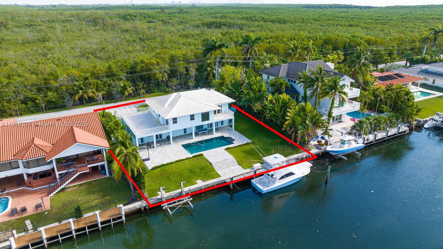 An aerial view shows a waterfront house with a pool, patio, and private boat dock — 1130 Lugo Ave, Coral Gables FL 33156, CORAL GABLES, FL
