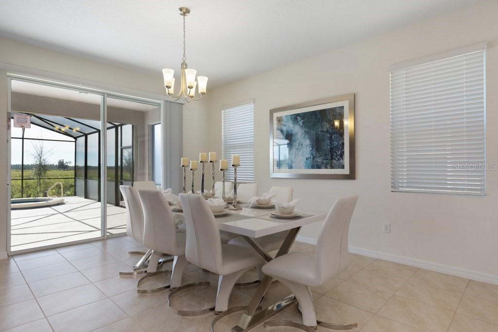 A dining room features a white table, six chairs, a chandelier, and a sliding glass door — 8012 OAK SHADOW COURT, DAVENPORT, FL