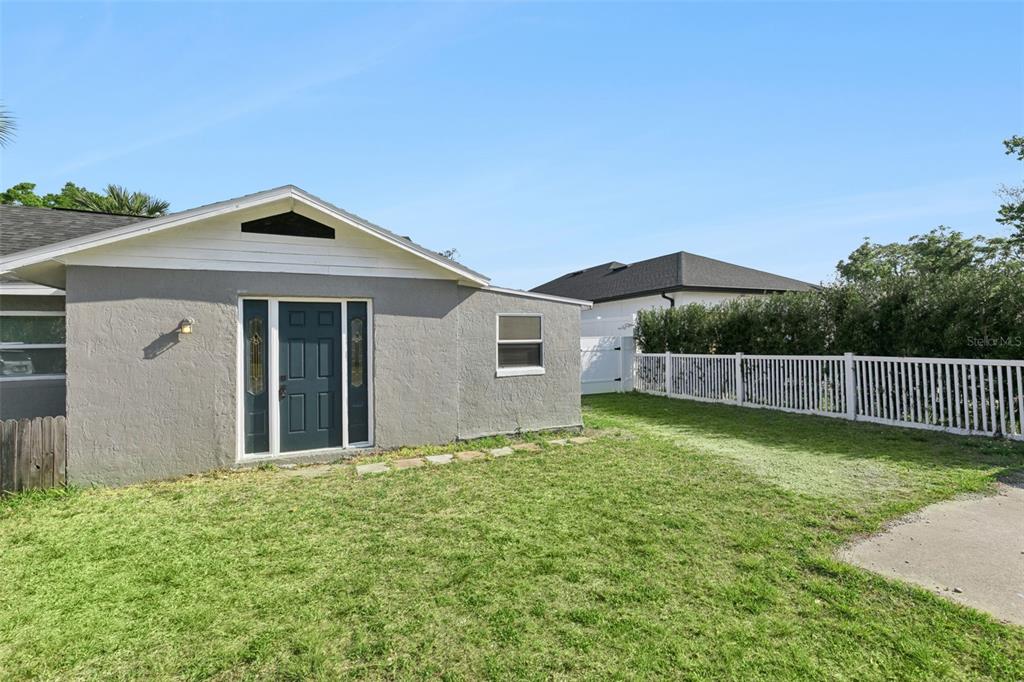 A gray house with a dark front door and a white fence in the yard — 5419 OLD CHENEY HIGHWAY, ORLANDO, FL