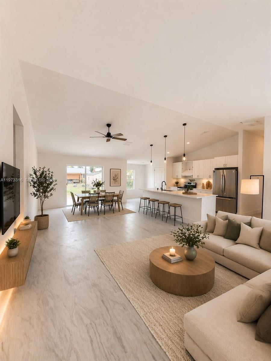 This collage shows a modern white kitchen with an island and a double-vanity bathroom — 9165 100th Ct, Vero Beach FL 32967, VERO BEACH, FL