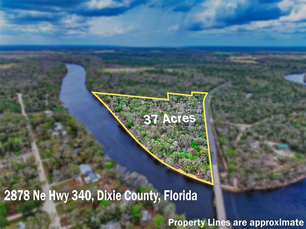 An aerial view shows a triangular plot of land bordered by a river — 2878 NE 340 HIGHWAY, BRANFORD, FL