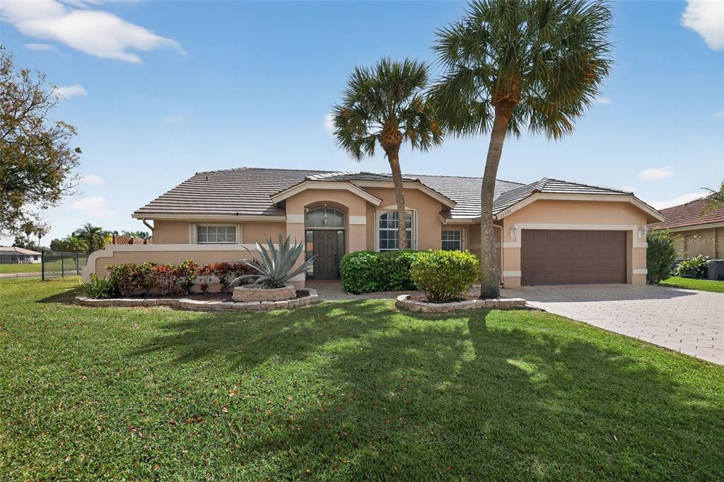 A single-story house with a tan stucco exterior, a tile roof, and a paved driveway — 12301 CABOT COURT, BOCA RATON, FL
