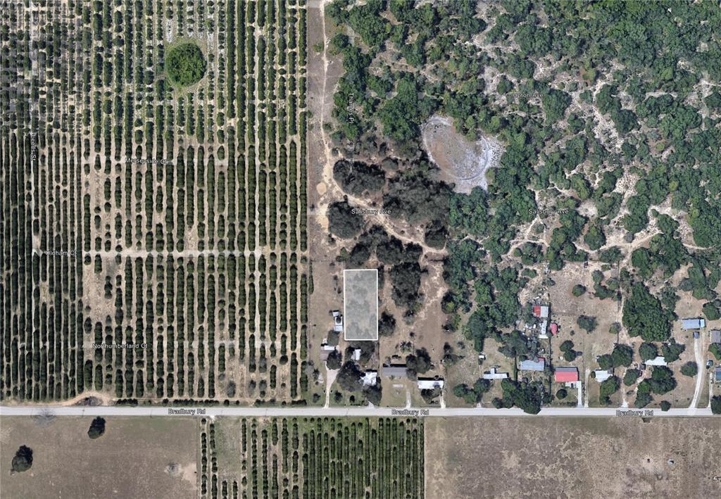 An aerial view shows a rectangular property lot outlined in white near a rural road — BRADBURY ROAD, HAINES CITY, FL