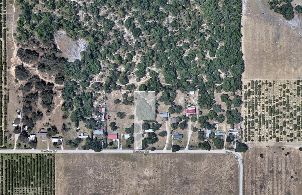 An aerial view shows a rectangular parcel of land highlighted within a rural residential area — BRADBURY ROAD, HAINES CITY, FL