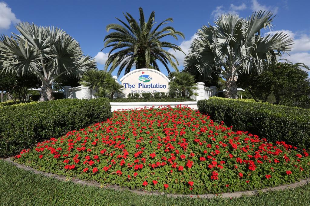 A sign for The Plantation Golf & Country Club sits behind a bed of red flowers — 818 WEXFORD BOULEVARD UNIT 818, VENICE, FL