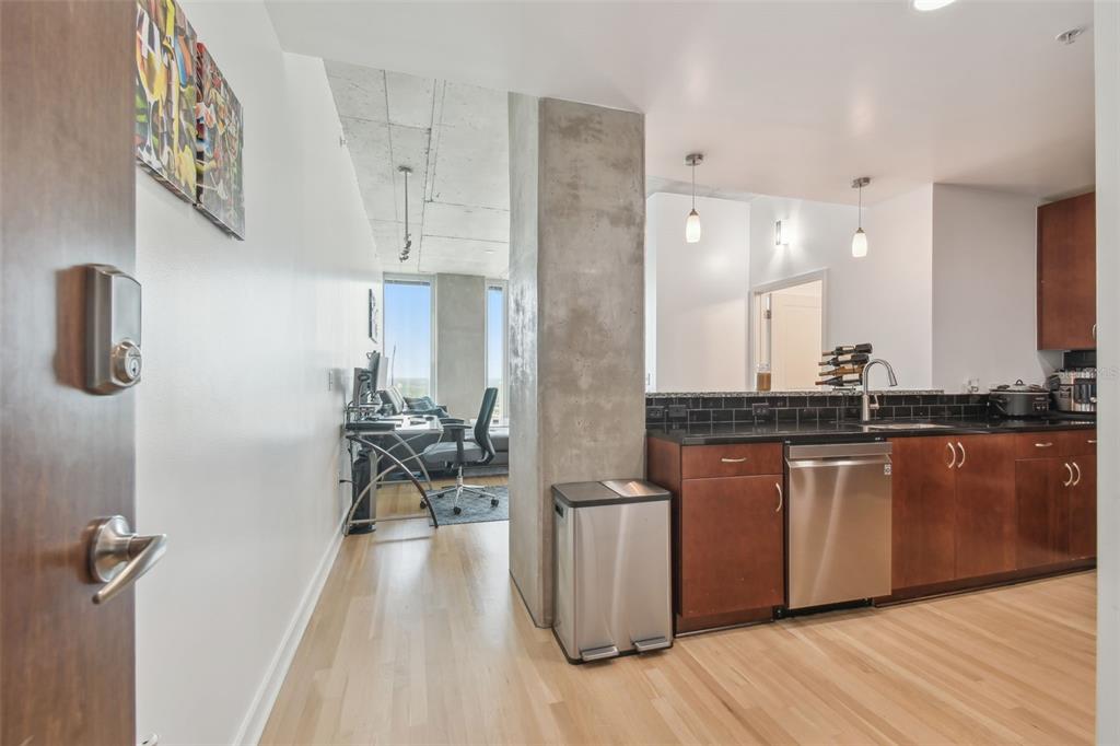 A view from a doorway looking into a kitchen with dark cabinets and a workspace — 777 N ASHLEY DRIVE UNIT 3009, TAMPA, FL
