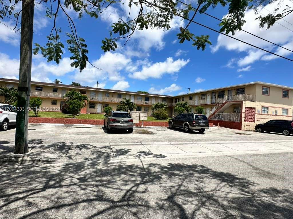 A two-story apartment building with a parking lot in front under a blue sky — 2651 NW 13th St # 41, Miami FL 33125, MIAMI, FL