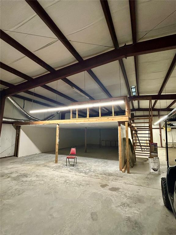 An interior view of a warehouse featuring a wooden loft structure and a concrete floor — 19808 N US HIGHWAY 441, HIGH SPRINGS, FL