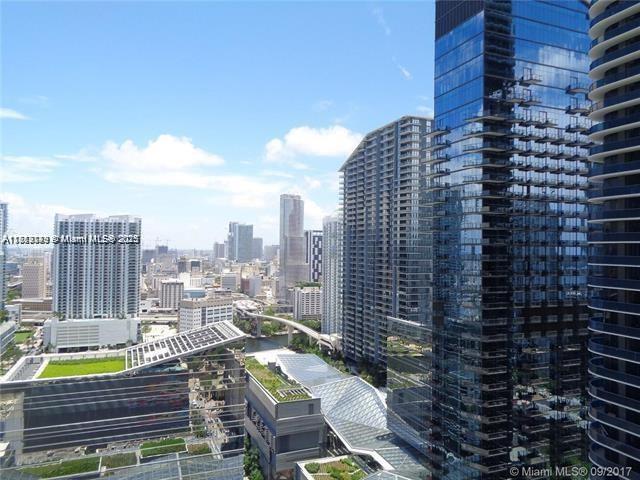 An elevated view of a dense urban skyline featuring modern glass skyscrapers and city streets — 45 SW 9th St # 2709, Miami FL 33130, MIAMI, FL