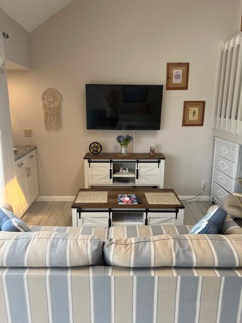 A living room features a wall-mounted television above a white and wood media console — 1605 S Us Highway 1, Jupiter FL 33477, JUPITER, FL