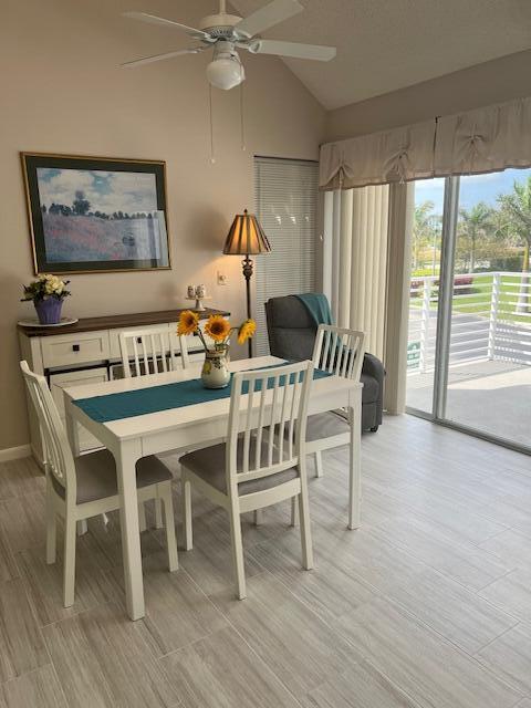 A dining area features a white table, chairs, a sideboard, and a sliding glass door — 1605 S Us Highway 1, Jupiter FL 33477, JUPITER, FL