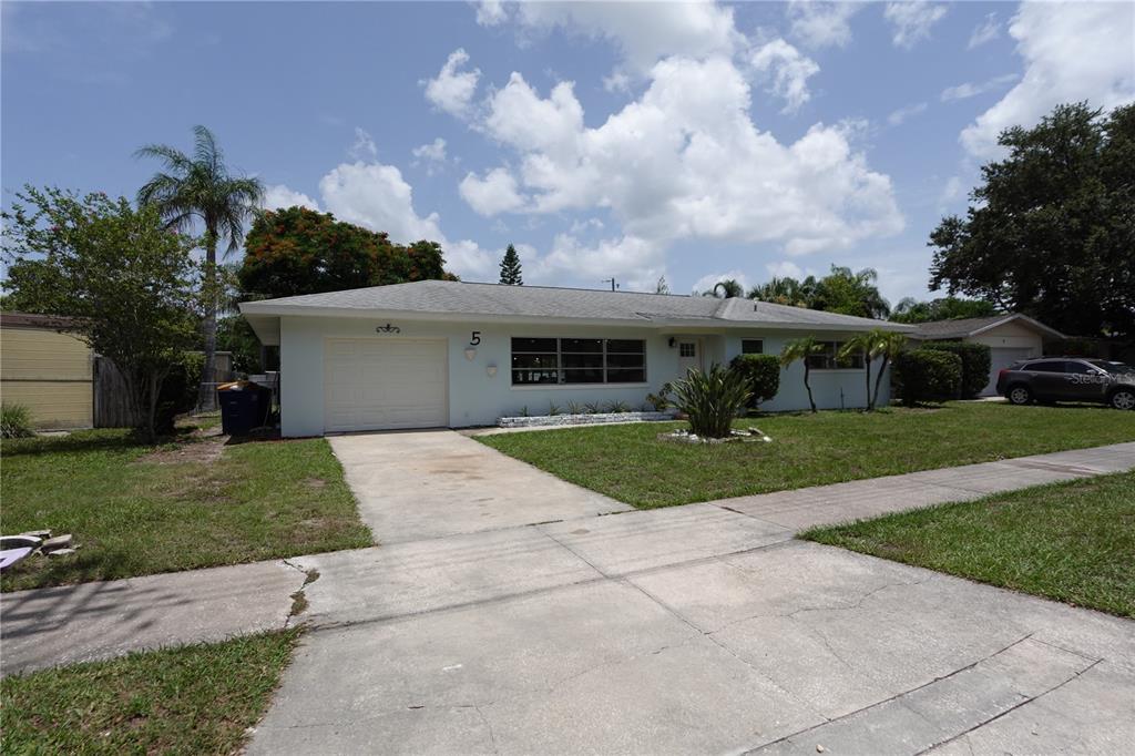 A single-story house with a white exterior, a one-car garage, and a concrete driveway — 5 S HERCULES AVENUE, CLEARWATER, FL