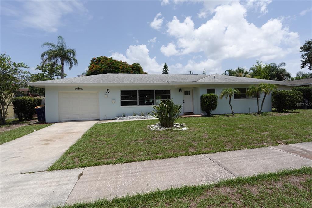 A single-story white house with a garage, front lawn, and a paved driveway — 5 S HERCULES AVENUE, CLEARWATER, FL