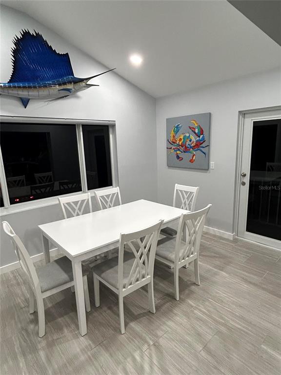 A dining area features a white table, four chairs, a sailfish mount, and crab artwork — 177 IROQUOIS STREET, TAVERNIER, FL