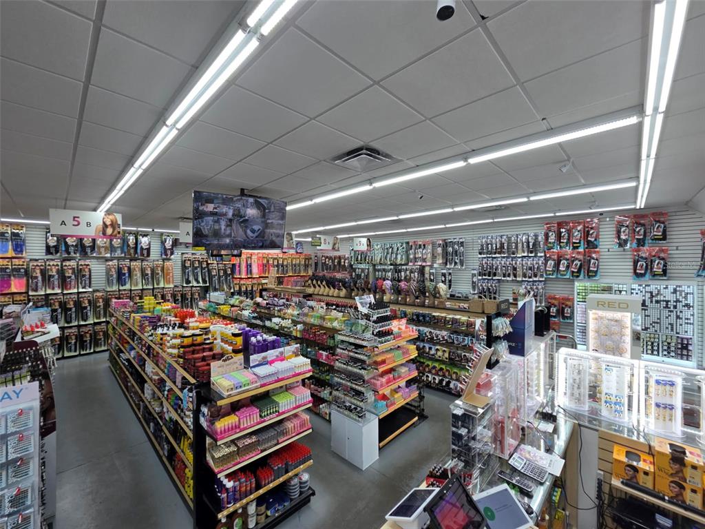 A retail beauty supply store features aisles of hair products and accessories under fluorescent lighting — 3401 N 22ND STREET, TAMPA, FL