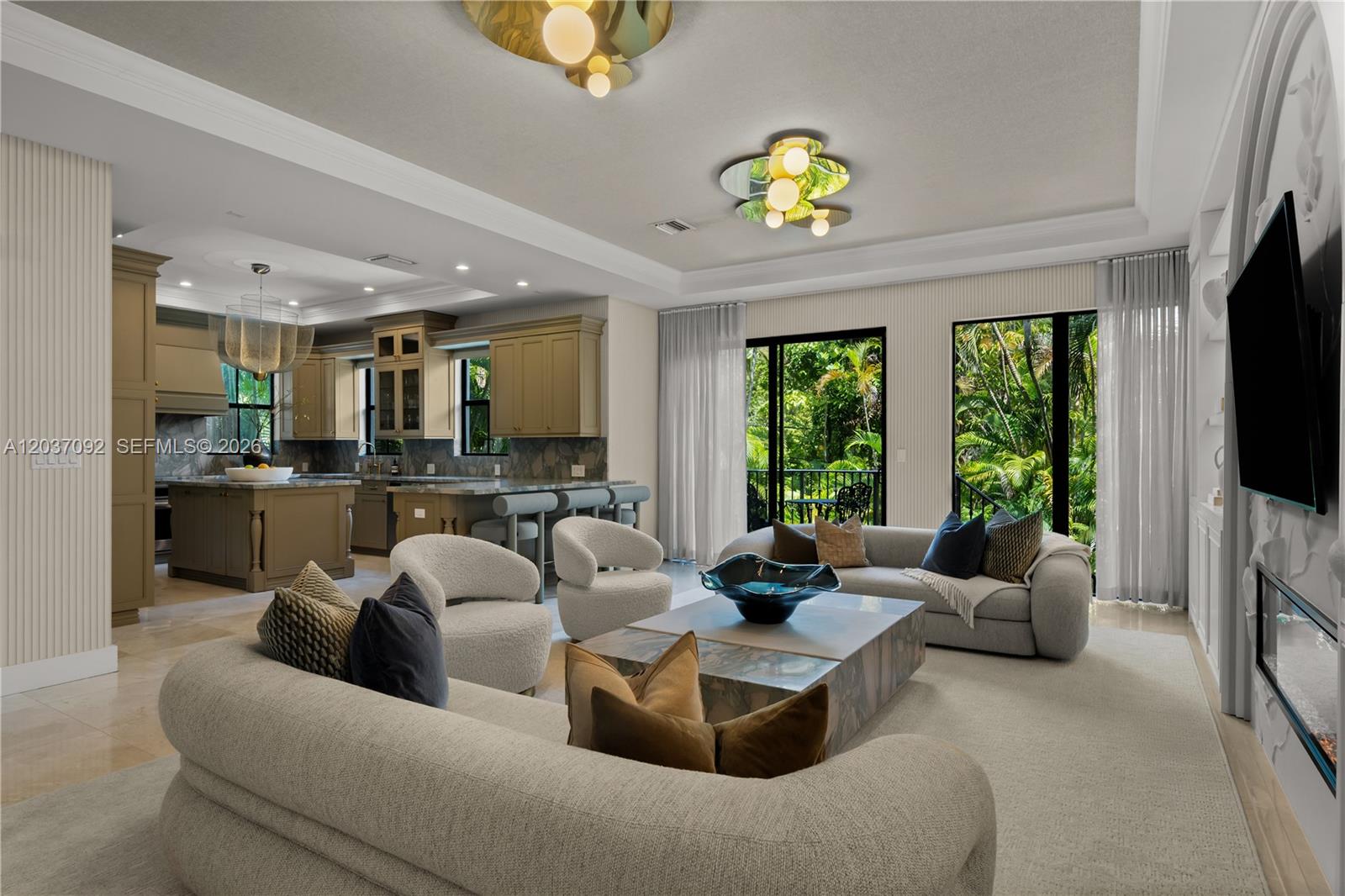 A modern open-concept living room and kitchen featuring neutral furniture, stone surfaces, and large windows — 1803 S Bayshore Ln, Miami FL 33133, MIAMI, FL