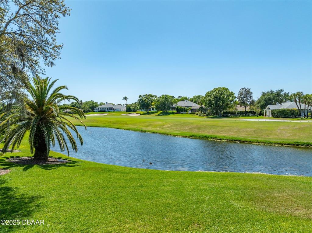 A view of a pond and manicured green lawn on a golf course — 203 PRESTWICK DRIVE, NEW SMYRNA BEACH, FL
