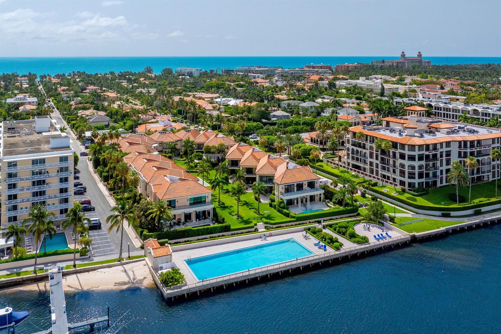 An aerial view of a waterfront residential complex with a large pool and surrounding homes — 307 Everglade Avenue, Palm Beach FL 33480, PALM BEACH, FL