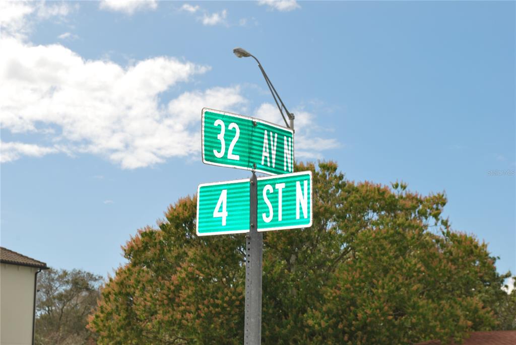 A street sign indicates the intersection of 32nd Avenue North and 4th Street North — 3185 4TH STREET N, ST PETERSBURG, FL