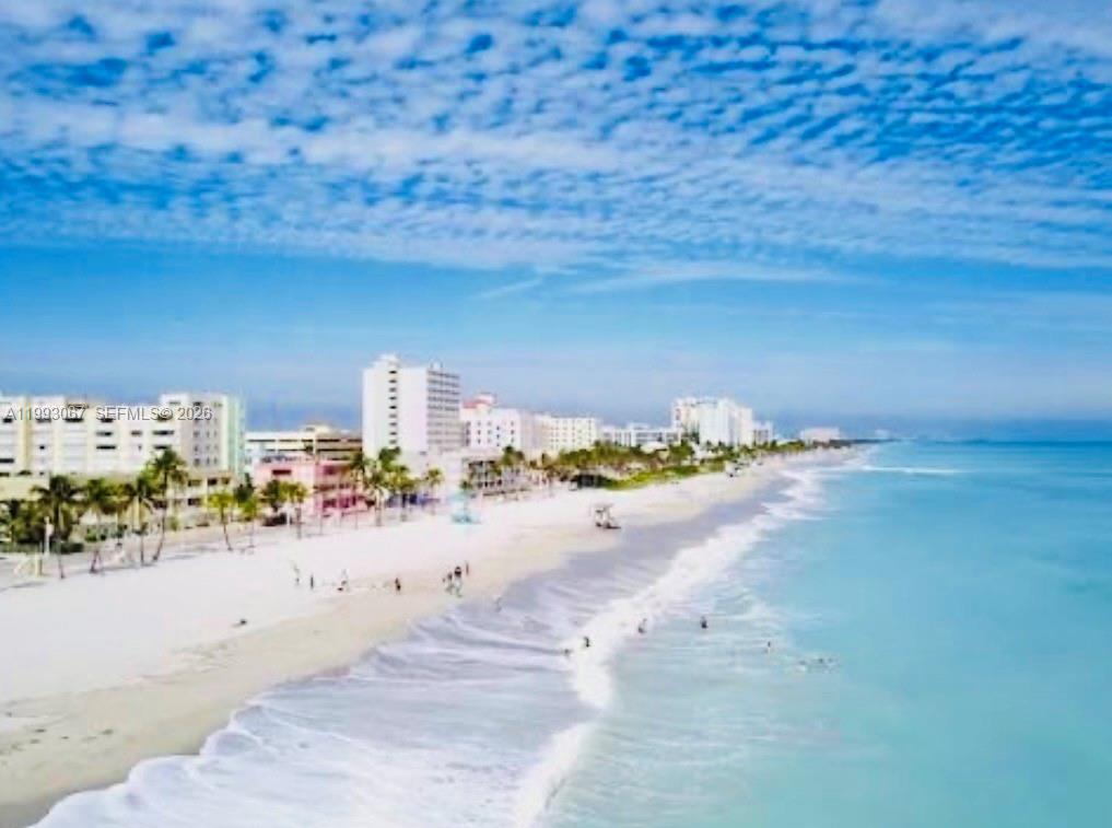 An aerial view of a sandy beach with ocean waves and a line of hotels — 1425 Arthur # 514B, Hollywood FL 33020, HOLLYWOOD, FL