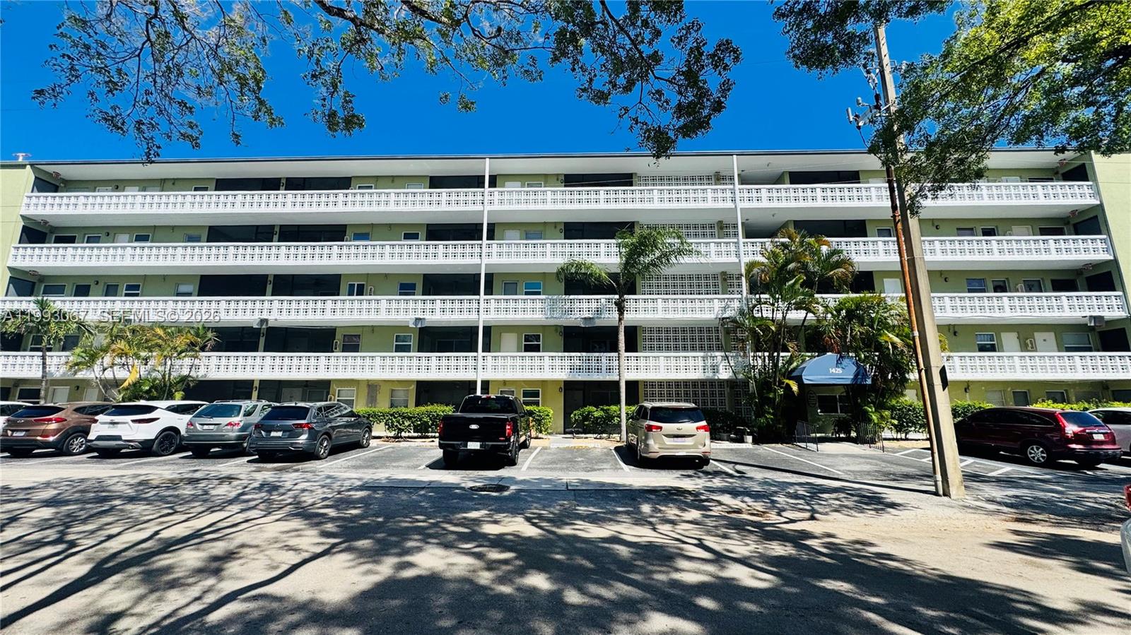 A four-story apartment building with balconies and a parking lot in front — 1425 Arthur # 514B, Hollywood FL 33020, HOLLYWOOD, FL