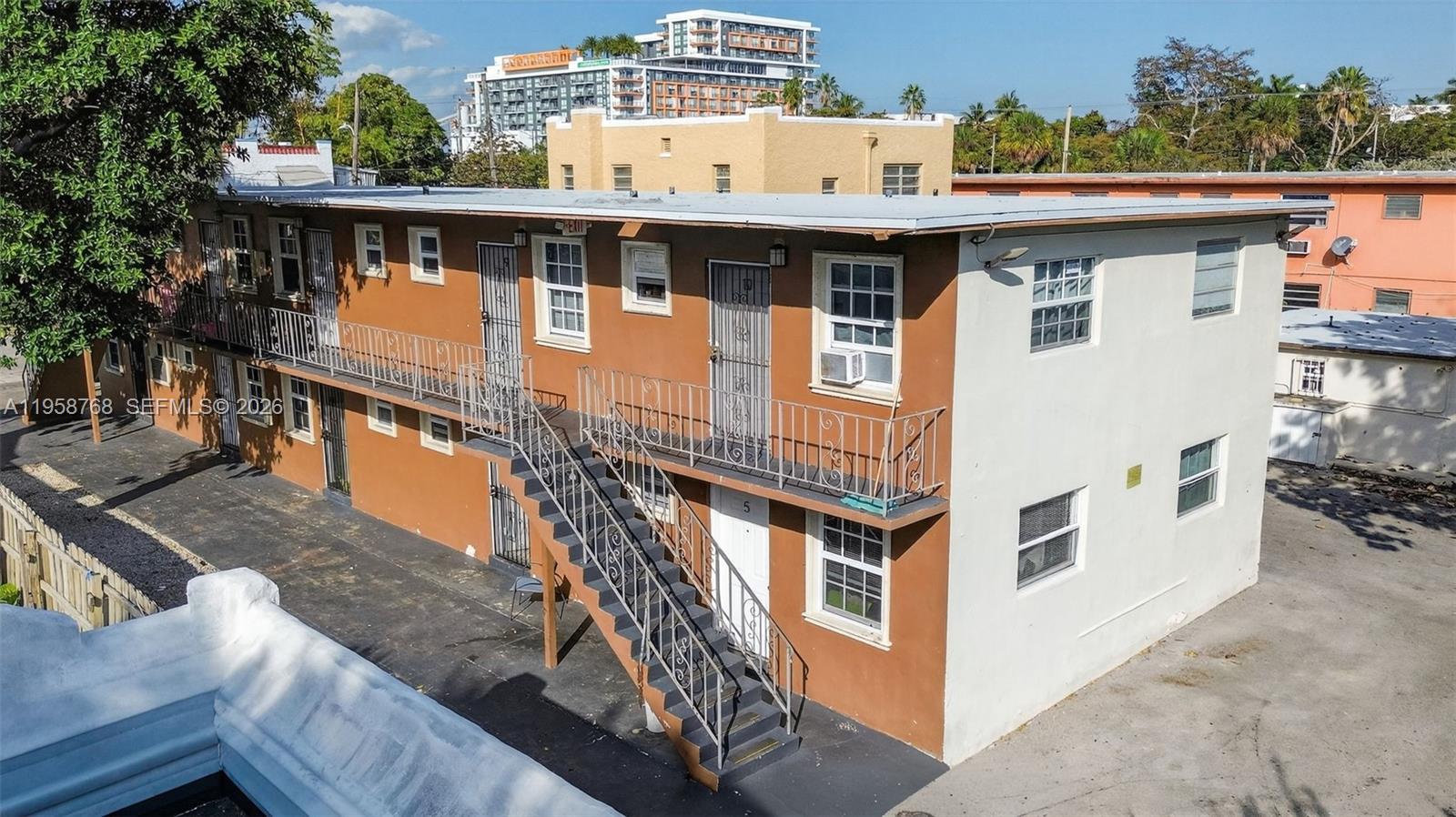 An exterior view of a two-story apartment building with a metal staircase and balcony — 1736 NW 19th St, Miami FL 33125, MIAMI, FL