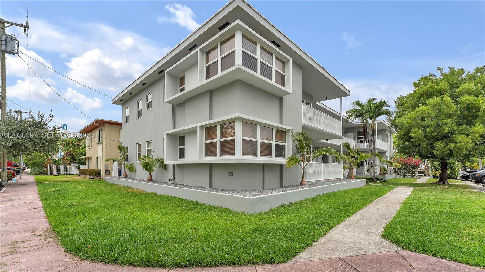 A two-story gray apartment building with corner windows and a white balcony — 1905 Calais Dr # 6, Miami Beach FL 33141, MIAMI BEACH, FL