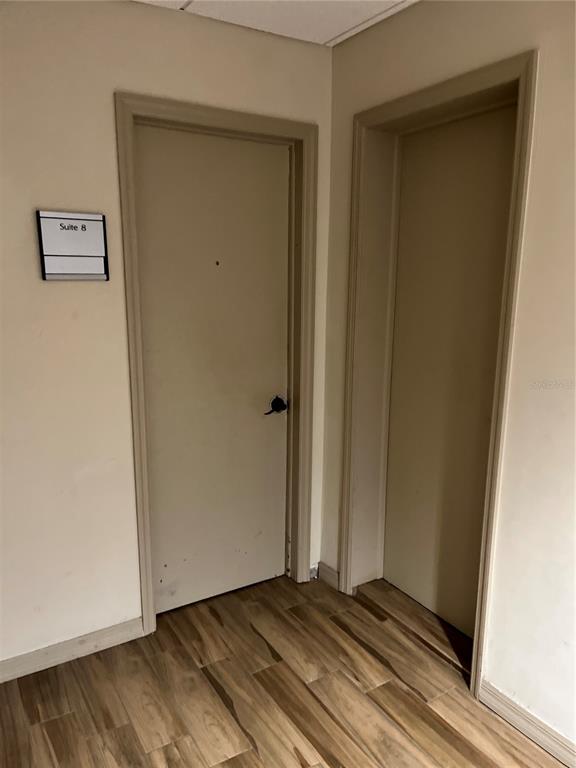 Two beige doors are set in a hallway with light wood-look flooring — 204 W UNIVERSITY AVENUE UNIT 8A, GAINESVILLE, FL