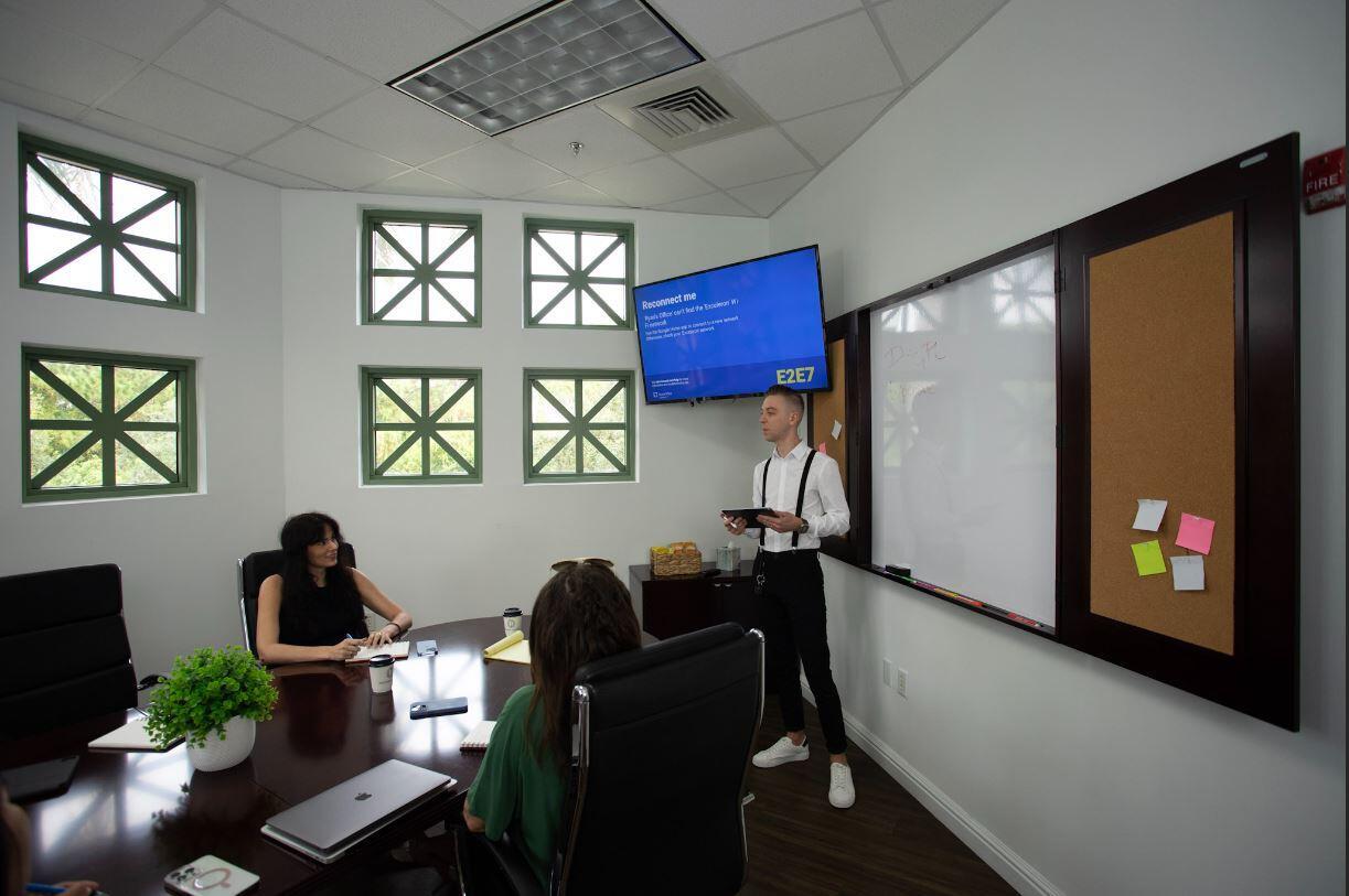 A conference room features a dark wood table, white walls, multiple windows, and a whiteboard — 601 Heritage Drive, Jupiter FL 33458, JUPITER, FL