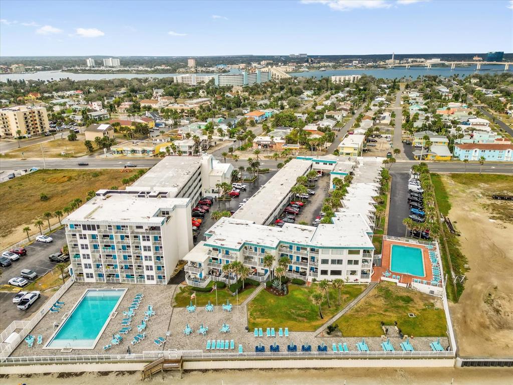 An aerial view of a multi-story hotel complex with two swimming pools near the beach — 935 S ATLANTIC AVENUE UNIT 239, DAYTONA BEACH, FL