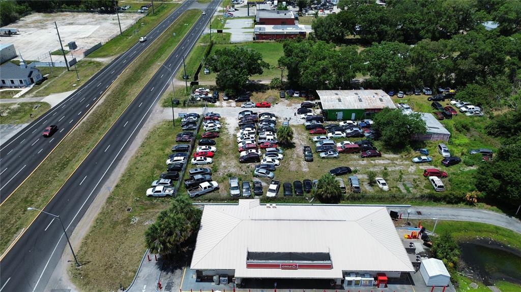 An aerial view shows a gas station with a large parking lot filled with cars — 4930 US HIGHWAY 92 E, LAKELAND, FL
