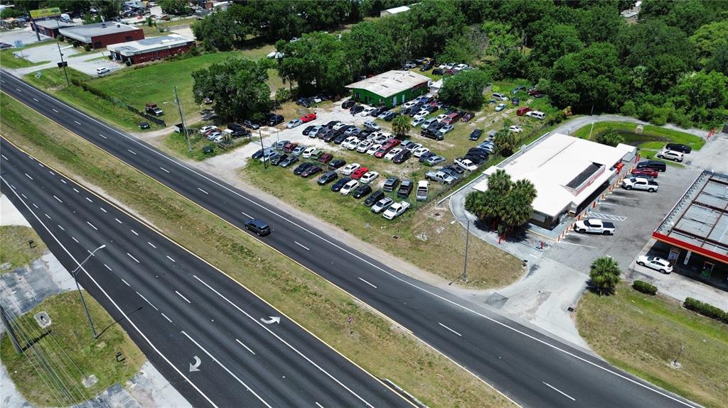 An aerial view shows a car dealership lot with many vehicles parked near a building — 4930 US HIGHWAY 92 E, LAKELAND, FL