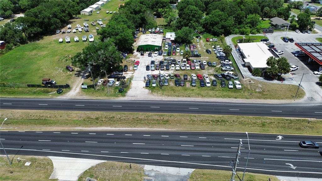 An aerial view shows a commercial property with a large parking lot filled with cars — 4930 US HIGHWAY 92 E, LAKELAND, FL