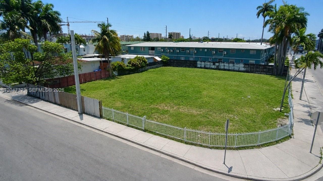 An aerial view shows a vacant, fenced-in grassy lot situated on a street corner — 895 NW 45th Ave, Miami FL 33126, MIAMI, FL