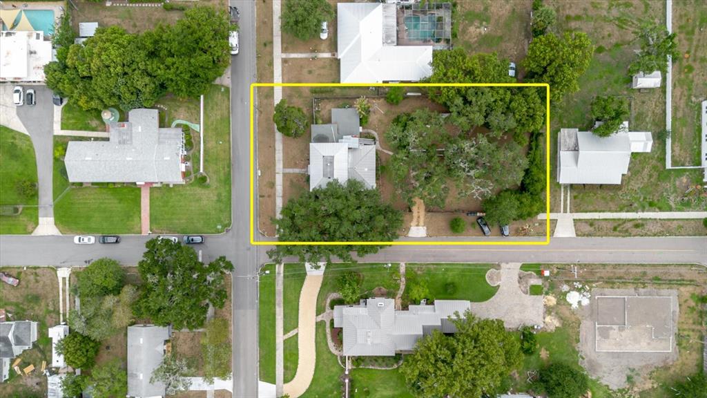 An aerial view shows a residential lot with a house, mature trees, and paved streets — 605 S JACKSON AVENUE, BARTOW, FL