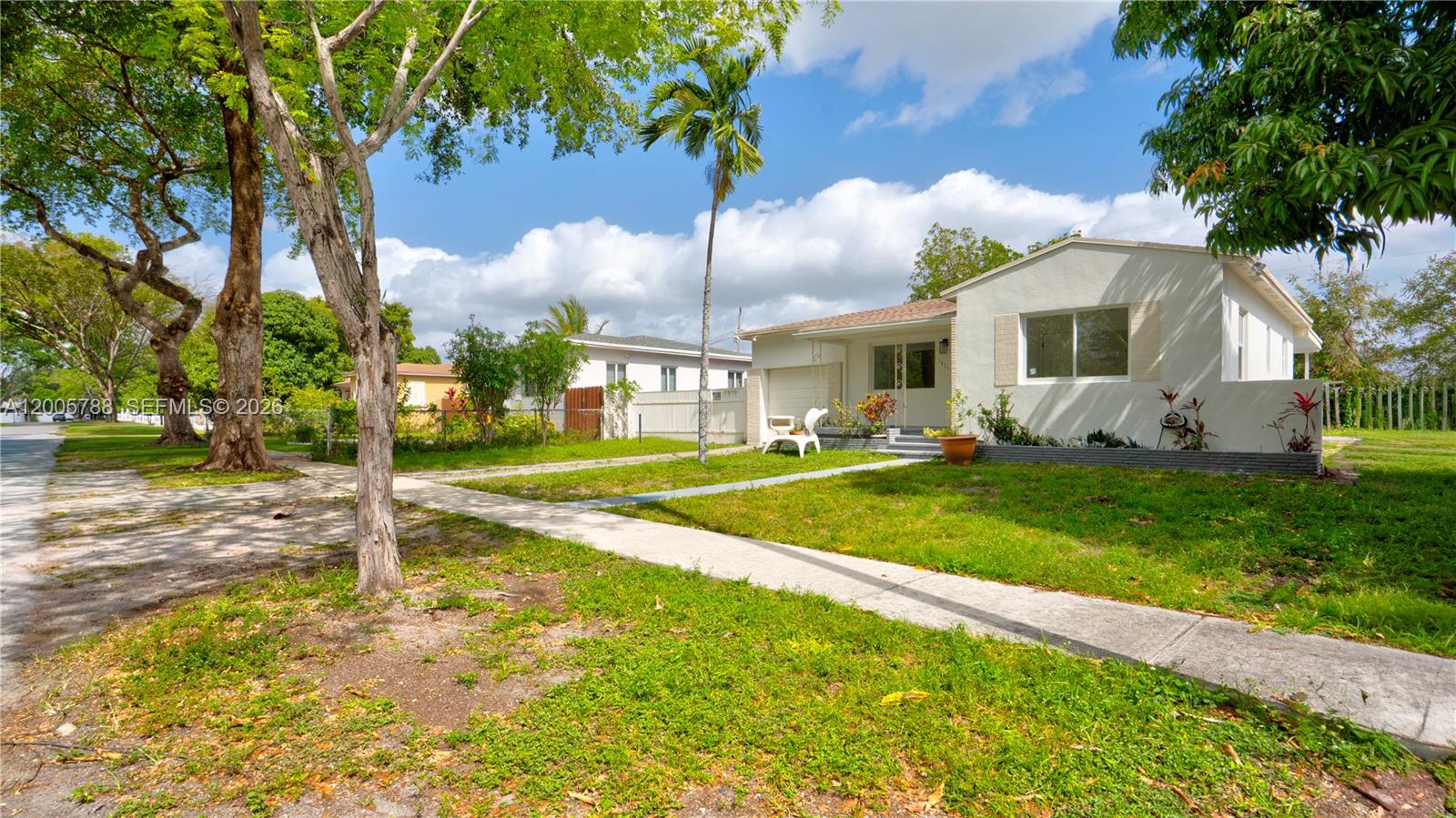 A single-story house with a white exterior, a front lawn, and a palm tree — 1921 NE 158th St, North Miami Beach FL 33162, NORTH MIAMI BEACH, FL