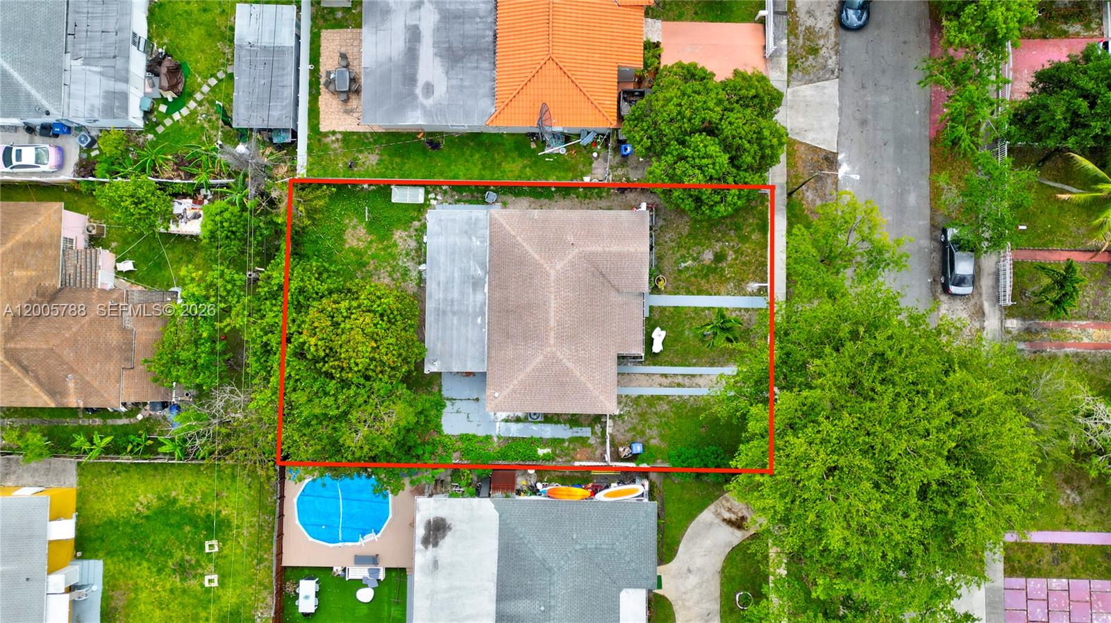 An aerial view shows a house with a brown roof centered on a grassy lot — 1921 NE 158th St, North Miami Beach FL 33162, NORTH MIAMI BEACH, FL