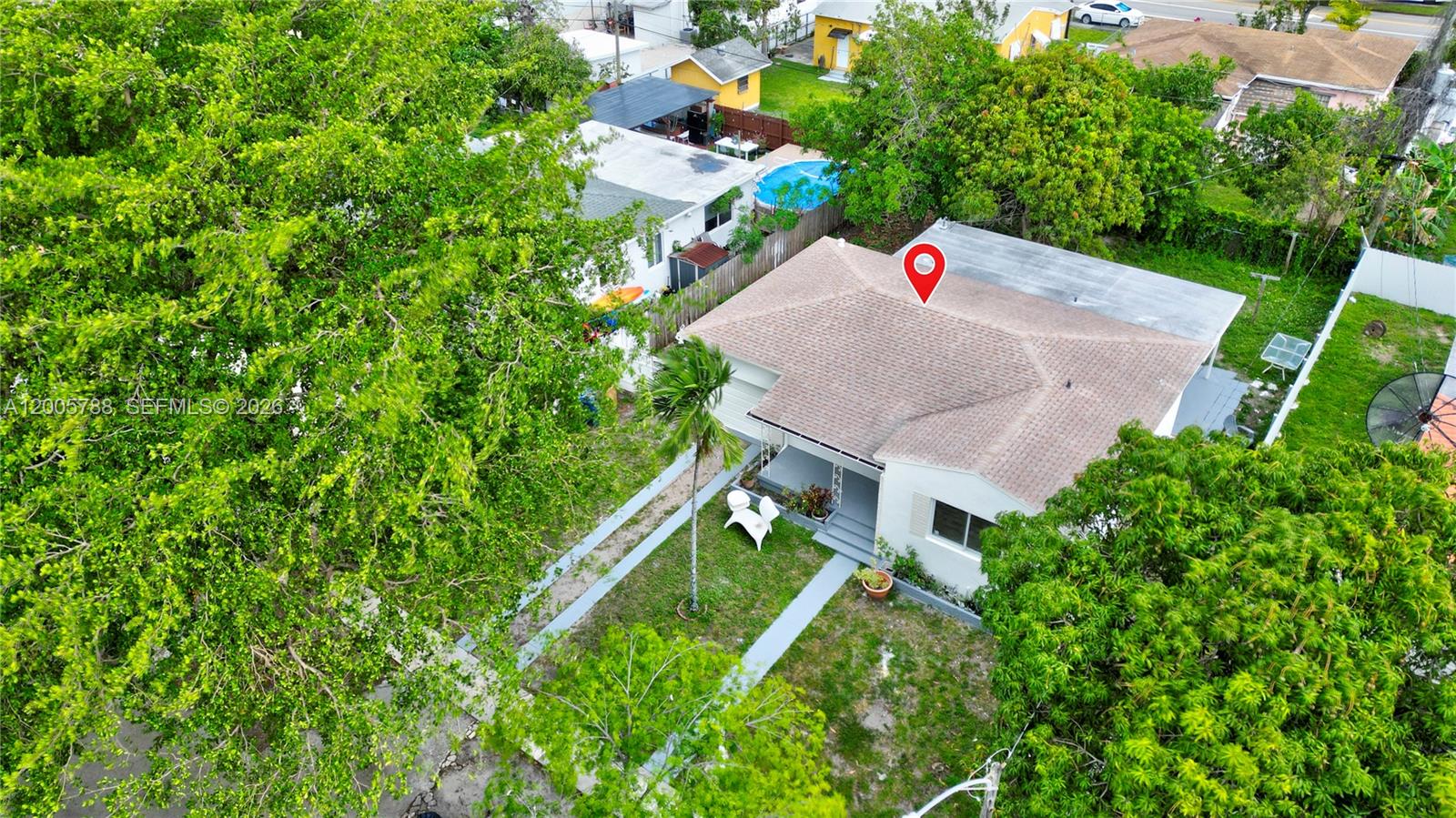 An aerial view shows a single-story house with a brown roof and a front yard — 1921 NE 158th St, North Miami Beach FL 33162, NORTH MIAMI BEACH, FL