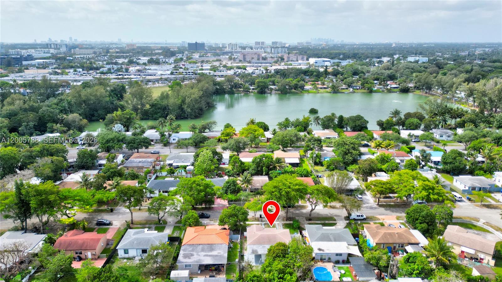 An aerial view shows a residential neighborhood with a lake and a marked house — 1921 NE 158th St, North Miami Beach FL 33162, NORTH MIAMI BEACH, FL