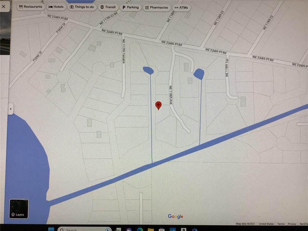 This is a map showing a residential area with a red pin marking a specific location — PARCEL 0013003044, FORT MC COY, FL