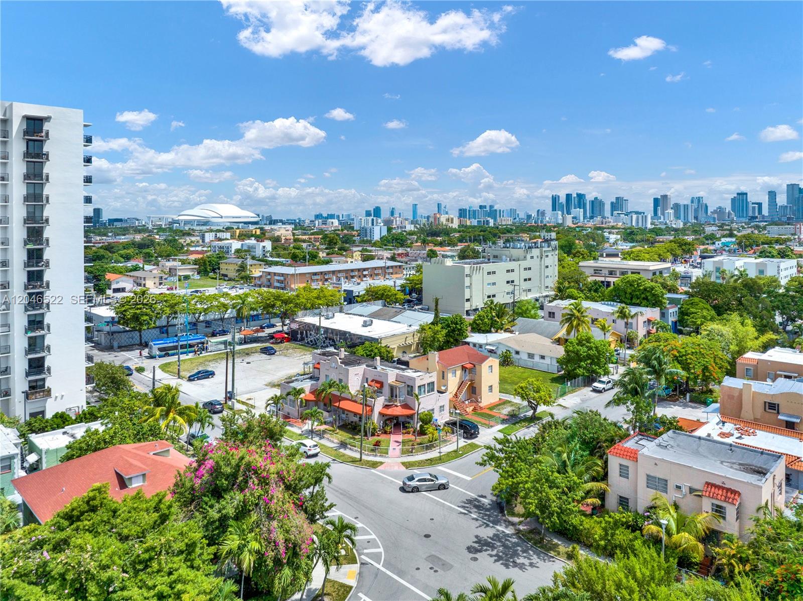 An aerial view shows a residential neighborhood with low-rise buildings, streets, and a distant skyline — 829 SW 19th Ave, Miami FL 33135, MIAMI, FL