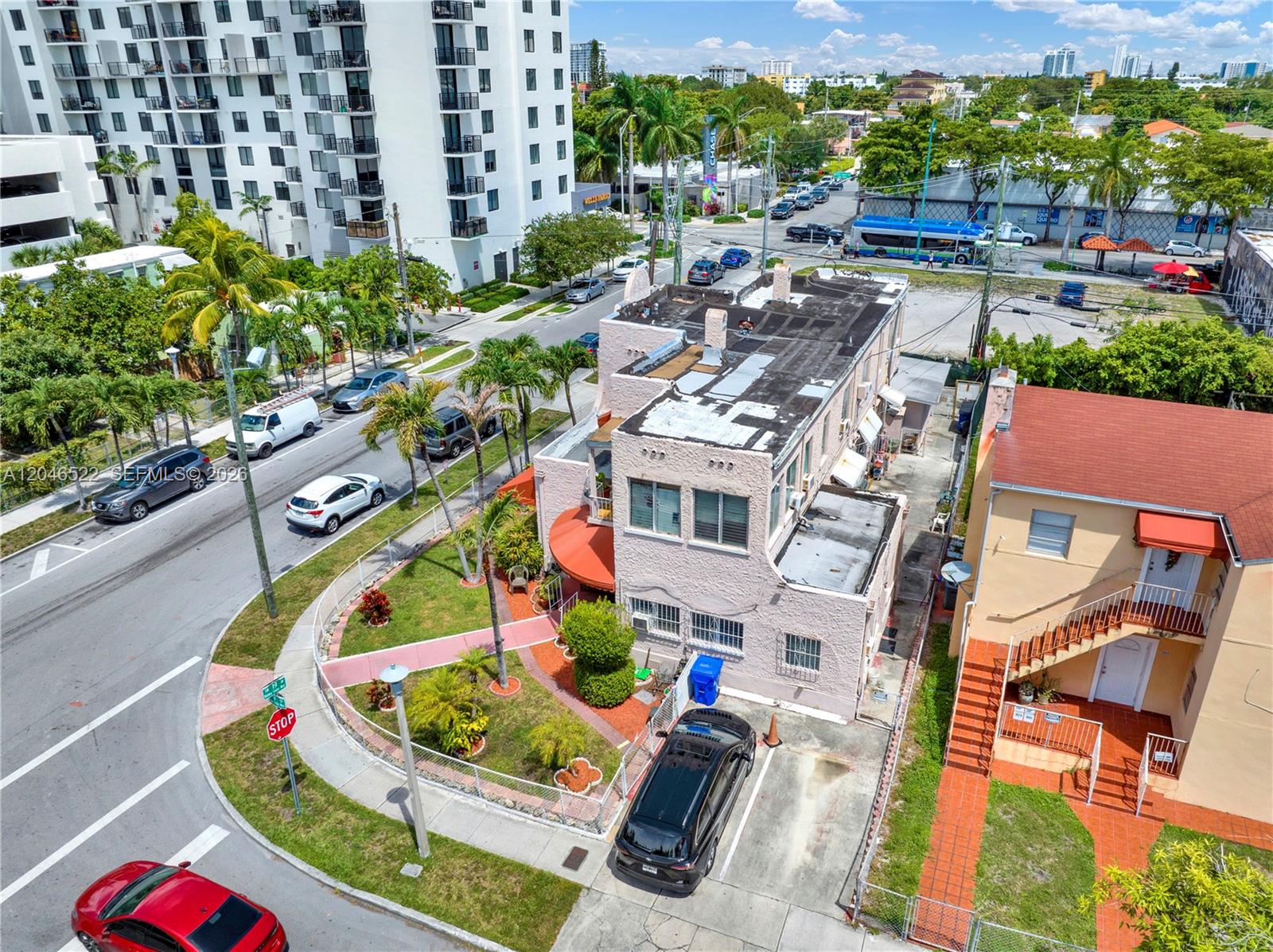 An aerial view shows a pink multi-story building with a flat roof and parking area — 829 SW 19th Ave, Miami FL 33135, MIAMI, FL