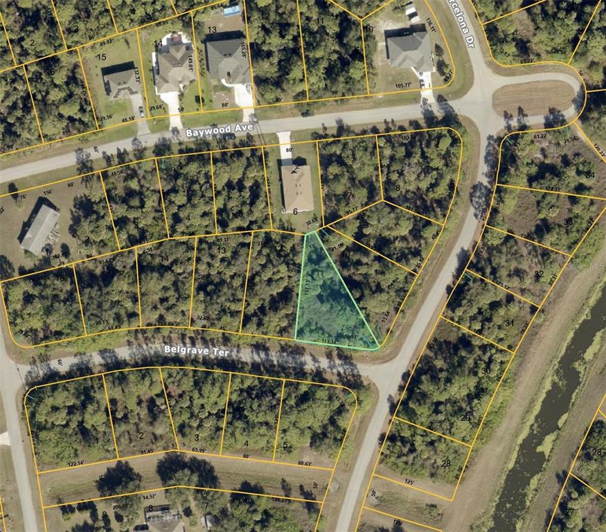 This is an aerial map showing residential lots and street layouts in a wooded neighborhood — Lot 11 BARCELONA DRIVE, NORTH PORT, FL