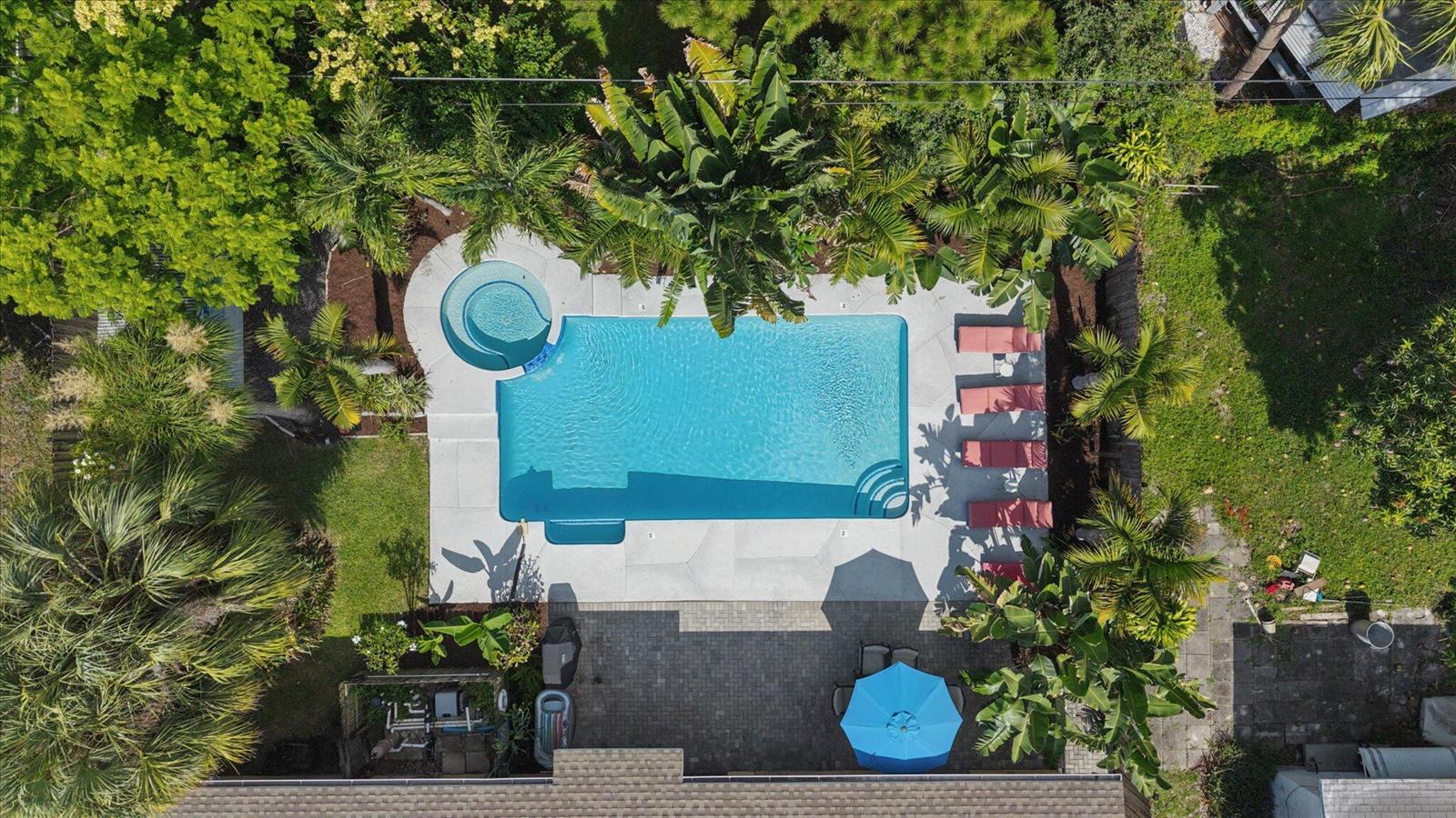 An aerial view shows a rectangular swimming pool with a spa, lounge chairs, and landscaping — 925 NE 25th Avenue, Pompano Beach FL 33062, POMPANO BEACH, FL