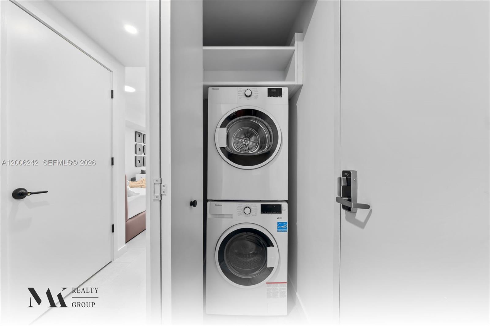 A stacked washer and dryer unit is located in a small closet — 121 NE 5 # 2700, Miami FL 33132, MIAMI, FL