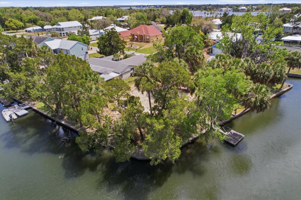 An aerial view shows a waterfront property with a house, trees, and a boat dock — 1941 NW 16TH STREET, CRYSTAL RIVER, FL