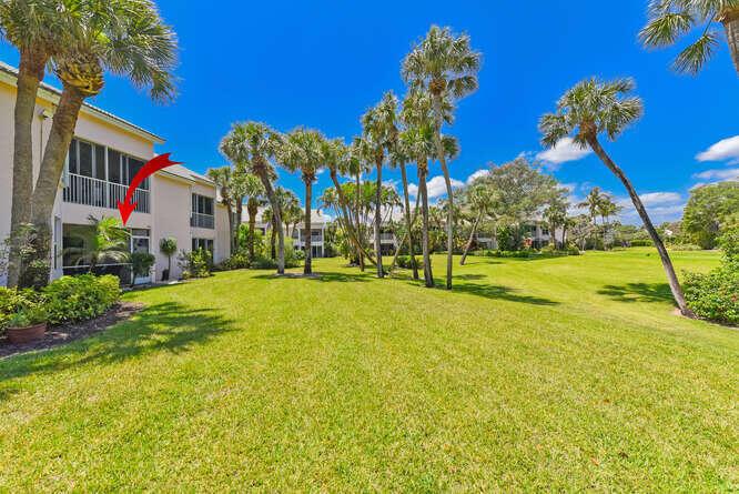 A ground-floor condo unit with a screened-in patio sits next to a large grassy lawn — 4105 FAIRWAY Drive N, Jupiter FL 33477, JUPITER, FL